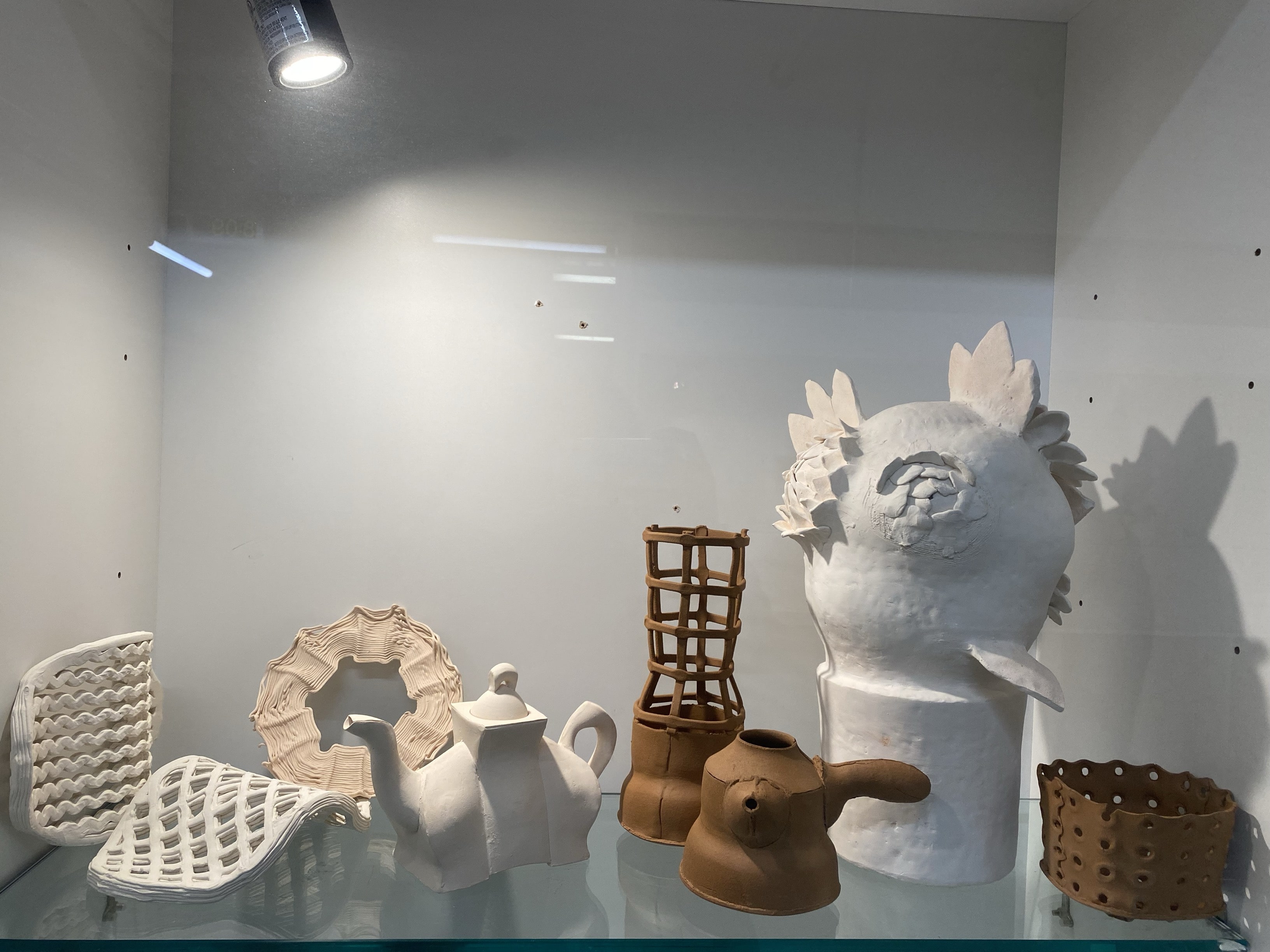 This one is some ornaments and jugs made of clay. They come in different colors and use a lot of different elements and techniques to make the shapes.